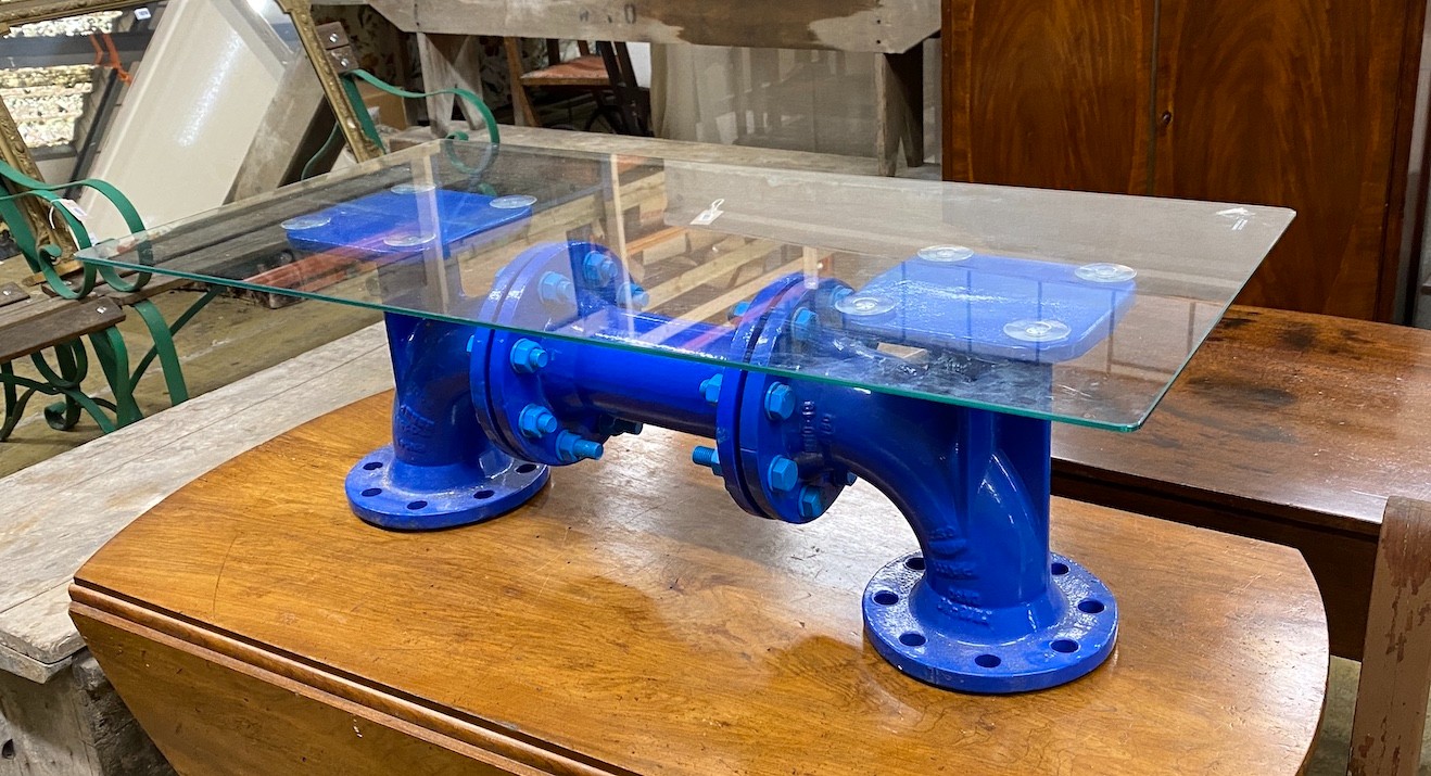 An industrial style cast iron steam pump glass top coffee table, length 93cm, width 48cm, height 29cm